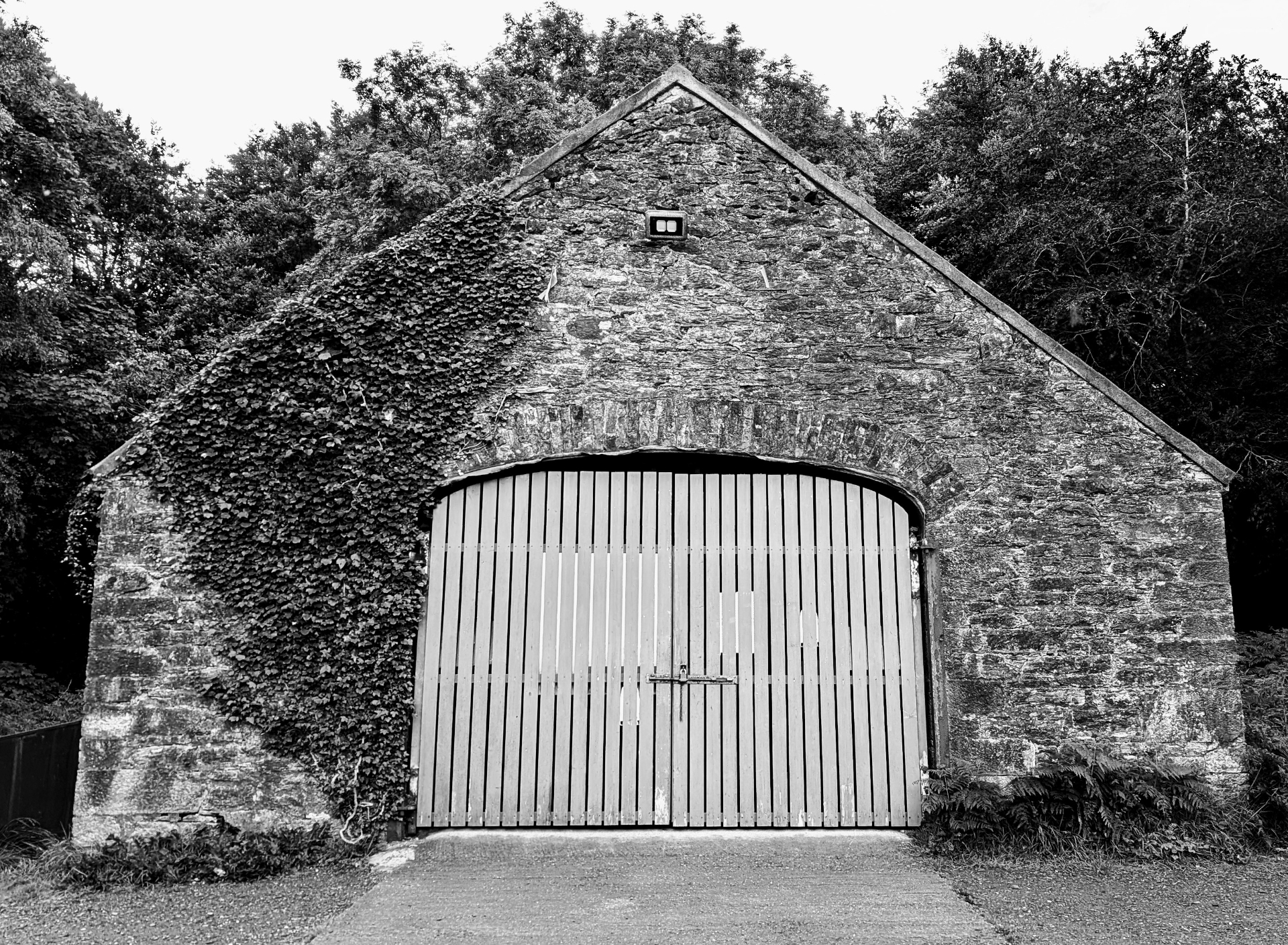 The historic stone Old Boathouse at Muckross, covered in ivy
